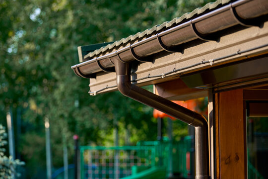 Roof line with brown gutters and wood soffit