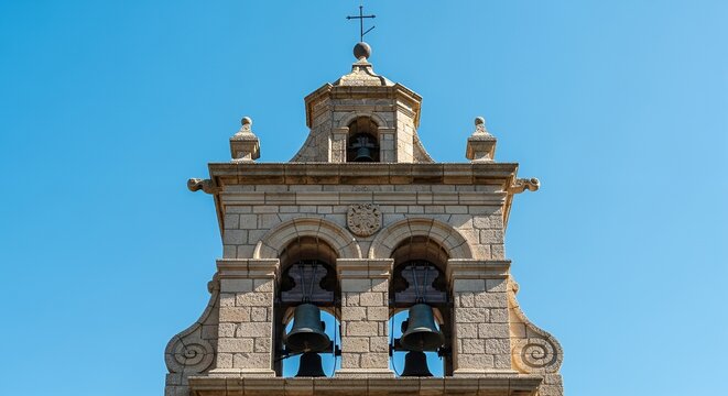 Stone bell tower with blue sky.