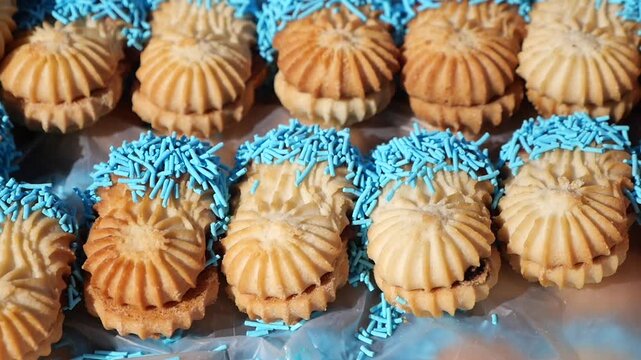 Delicious cookies with blue sprinkles on display