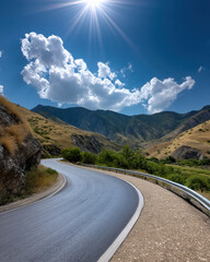Obraz premium Curved asphalt road mountain blue sky sun cloud summer scenic nature outdoor landscape. Curved asphalt road winds through mountain landscape