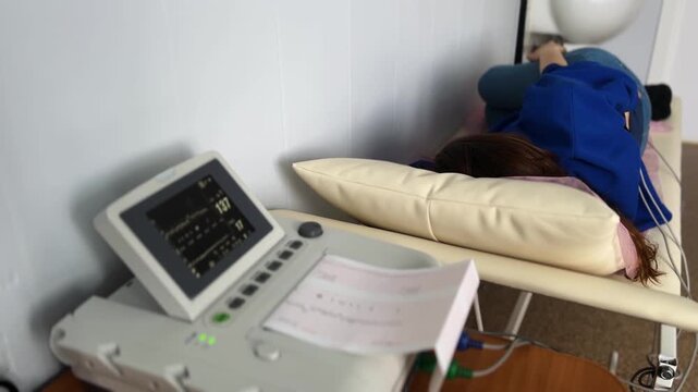 Expectant mother undergoing a non-stress test at a hospital using cardiotocography to monitor the fetal heart rate, ensuring a healthy pregnancy and upcoming childbirth