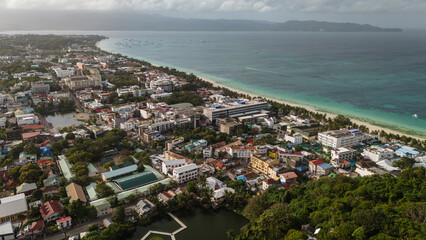 Fototapeta premium A stunning aerial drone panorama of Boracay Philippines island iconic White Beach, featuring turquoise waters, white sand, and beachfront resort infrastructure on a clear day