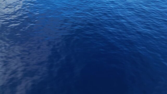 Aerial drone view of calm ocean with mirror like surface and soft diffused storm lighting