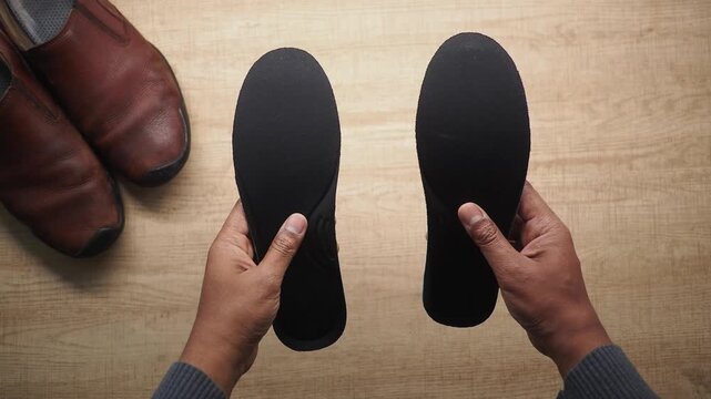 Inserting insoles into shoes for comfort support