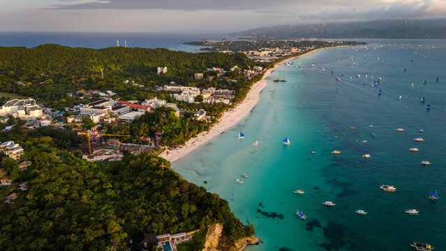 Aerial view of the world-famous White Beach in Boracay, Philippines. Crystal clear turquoise waters, white sand, and luxury resorts along the tropical coastline