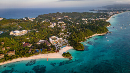 drone above Boracay at White Beach, vibrant turquoise ocean and white sandy shoreline lined with palm trees and resorts, Philippines travel holiday © Michele