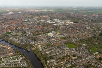 Fototapeta premium Aerial view photo of the city of York in the UK with River Ouse terraced housing caravan park and York Minster visible in the distance captured from above in early spring time