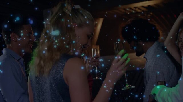 Vertical video: Drifting blue spark over bar as blond in glitzy top raising flute smiling cheering
