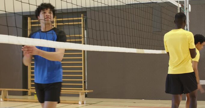 Three adult males in yellow shirts, after handshakes, aligning front row at net, blocking attack