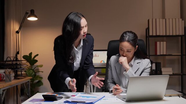 Angry manager scolding employee for poor performance at night