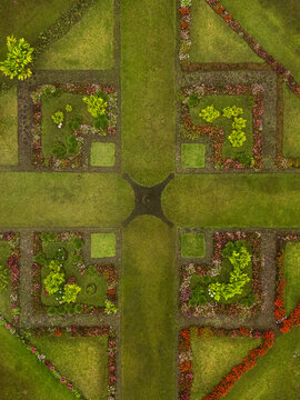 Aerial view of a meticulously designed garden with vibrant flowers and verdant grass converging at a central nexus, Cinchona, Alajuela Province, Costa Rica.