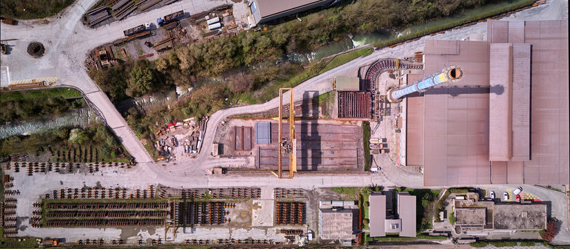 Olaberria, Spain - 09 March 2026: Aerial view of the ArcelorMittal steel mill, where rust-colored structures contrast sharply with the green vegetation, showcasing the industrial landscape.
