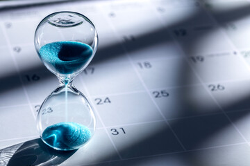 Hourglass on calendar background © Brian Jackson