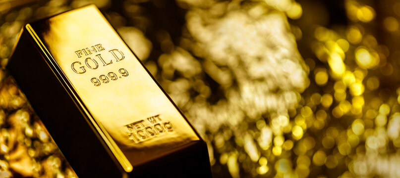 Gold bullion bar or ingot background concept for investment, stocks and shares trading or banking