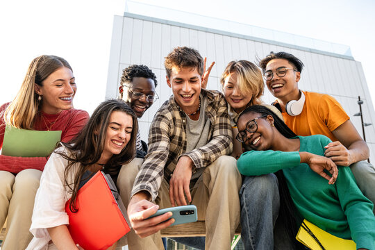 A Diverse Group of Friends Enjoying Quality Time Together While Using a Smartphone