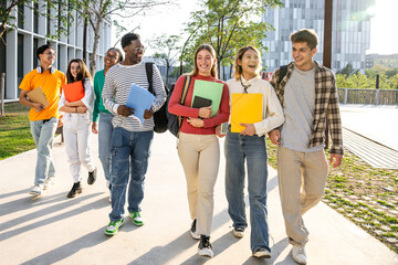 Fototapeta premium A diverse and vibrant group of students walking together on campus, enjoying nature and sunshine