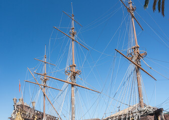 Historic sailing ship docked in sunny Mediterranean harbor. Bright blue sky and marina atmosphere. Concept of travel and coastal tourism © Elena