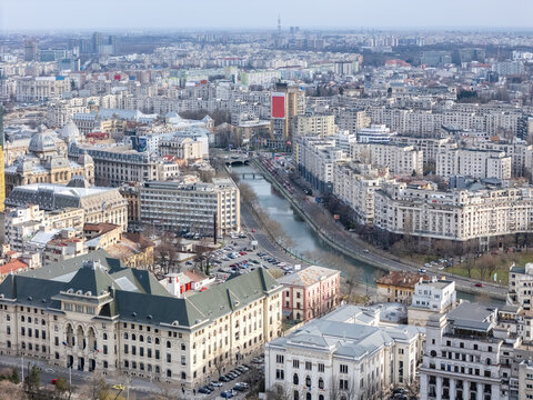 Aerial view of Dambovita River gracefully curving through the heart of Bucharest, where architectural grandeur meets the urban sprawl, Bucharest, Bucharest, Romania.