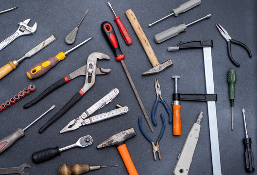 Collection of various hand tools top view hammers screwdrivers pliers, wrenches and clamps. DIY repair background.