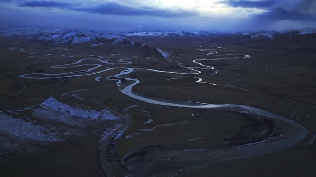 Aerial panoramic view of Manzetang Wetland Nature Reserve at twilight: The winding Jiaqu River under the blue hour on the Zoige Plateau