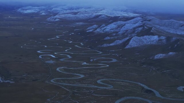 Aerial panoramic view of Manzetang Wetland Nature Reserve at twilight: The winding Jiaqu River under the blue hour on the Zoige Plateau