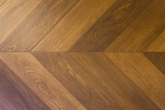 Close up view of wooden surface showing a geometric chevron pattern background texture detail