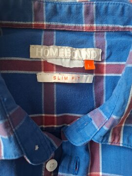 Blue and Red Plaid Button Up Shirt Hanging on Neutral Background