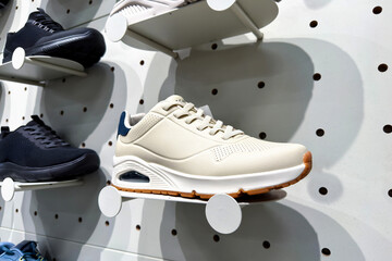 New athletic sneakers collection on a stylish white pegboard wall for retail shopping display