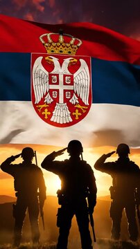 Patriotic Serbian soldiers saluting the national flag during sunset with silhouettes and vivid colors