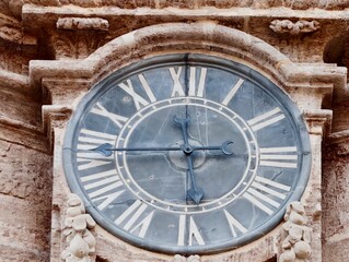 Obraz premium Ancient Stone Watch Face, Time Of Ancient Stone Clock With Ornate Carvings During Dusk Hours