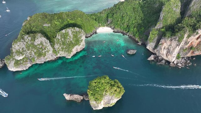 Aerial view of the stunning limestone cliffs meeting the turquoise waters, creating a breathtaking contrast of textures and colors, Kho Phi Phi Island, Thailand.