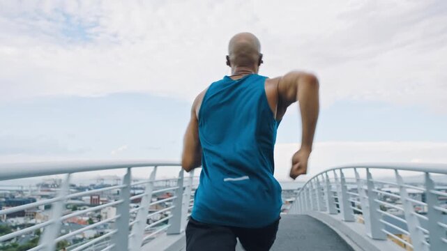 Fitness, running or man on bridge with earphones, cardio playlist or stamina exercise in speed activity. Fast, intense sprint or athlete with tech, sports podcast or endurance workout in city.