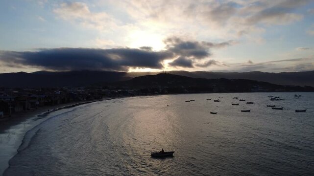 Drone pushing forward over the bay of a small fishing town.