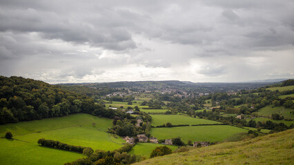 Fototapeta premium Cotswold landscape panorama. Gloucestershire, England. Rolling hills, green fields, rural idyll.