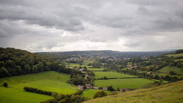 Cotswold landscape panorama. Gloucestershire, England. Rolling hills, green fields, rural idyll.