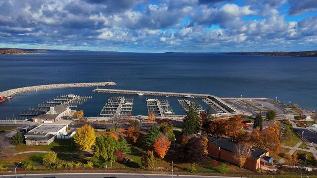 Grand Traverse Bay marina and autumn trees in Traverse City, Michigan, USA in aerial view