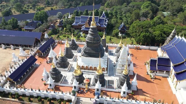 Aerial view of Wat Phra Kaew temple complex showcasing the vibrant blue roofs contrasting with the gold and white spires, Wat Phra Kaew, Thailand.