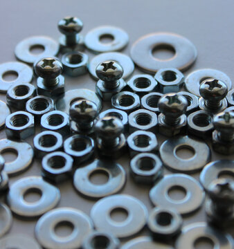 Screw Bolts, Threaded Bolts And Flat Washers Fitted Each Other On White Surface Macro Shot Stock Image
