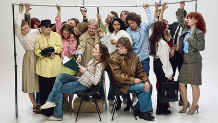 Crowded subway passengers sitting and standing holding rail in tight space. Concept of commuter...