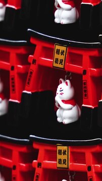 Traditional Japanese tourist souvenirs and gifts from Kyoto, Kansai, Japan, with daruma figures, kitsune fox, tengu mask, fridge magnets, toys figurines, key ring keychain, in a local vendor gift shop