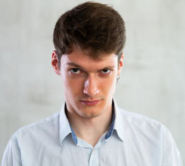 Fototapeta premium Portrait of an angry man on gray background