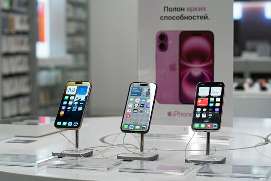 Showcase with smartphones in the electronics store. The new Apple iPhone 16 series on display at a brand store. Buy a mobile phone. Minsk, Belarus - March 31, 2025