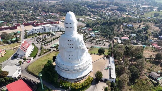 Aerial view of the imposing white statue and temple complex of Wat Huay Pla Kang, contrasting against the surrounding green hills, Wat Huay Pla Kang, Thailand.