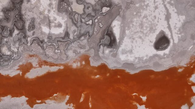 Aerial view of the stark contrast between the reddish waters and the pale shores of Laguna Colorada, creating a stunning natural palette, Laguna Colorada, Bolivia.