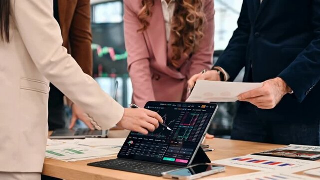 Business Team Collaborating on Financial Reports and Digital Tablet | Professionals Discussing Investments with Charts and Documents | Corporate Meeting Analyzing Market Data TogetherBusiness Team Col