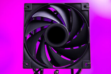 Fototapeta premium Black cooling fan with purple background used in computer setups for better airflow and temperature management during operation