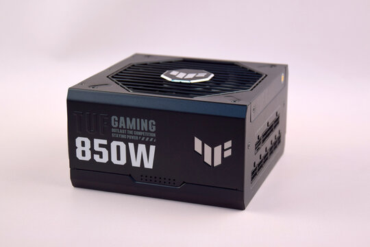 Computer AC power supply Asus Tuf 850w on a light background.