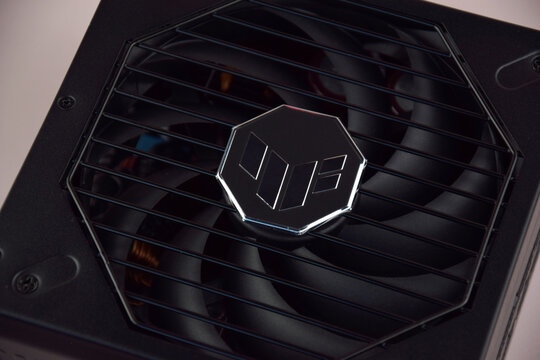 Computer AC power supply Asus Tuf 850w on a light background.