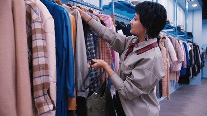 Fototapeta premium Woman Shopping for Clothes in Fashion Store, have fun and enjoy