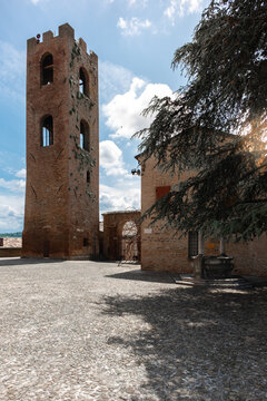 View of sun-kissed stone tower rises majestically against a backdrop of azure skies, whispering tales of ancient times and architectural grandeur, Longiano, Italia.